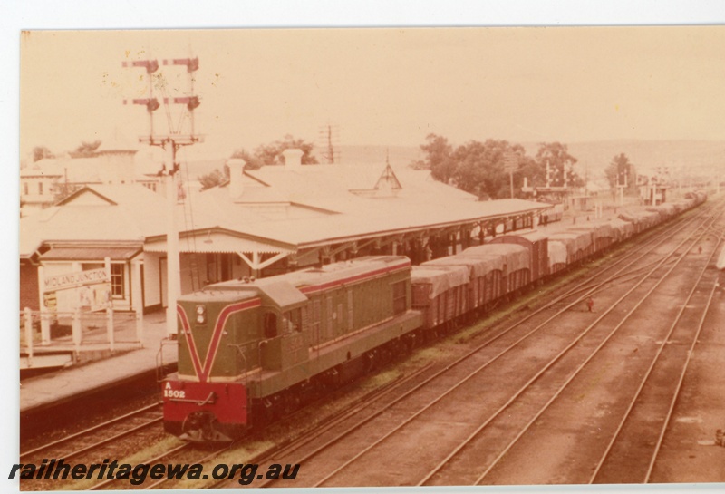 P16350
A class 1502, on goods train, station building, platforms, bracket signals, Midland Junction, ER line, front and side view
