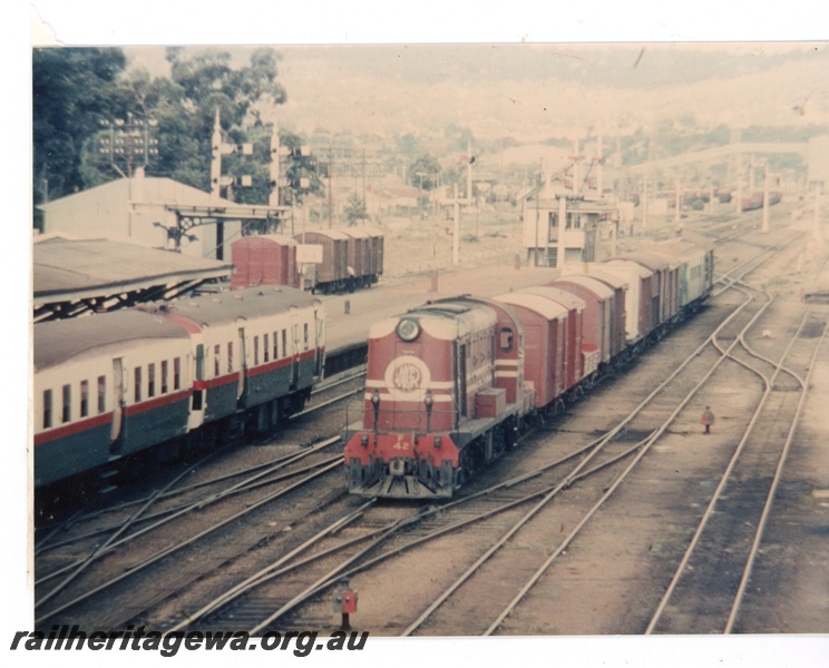 P16376
Ex MRWA F class 42, on goods train, platform, canopy, bracket signals, signals, signal box, Midland Junction, ER line, front and side view from elevated position
