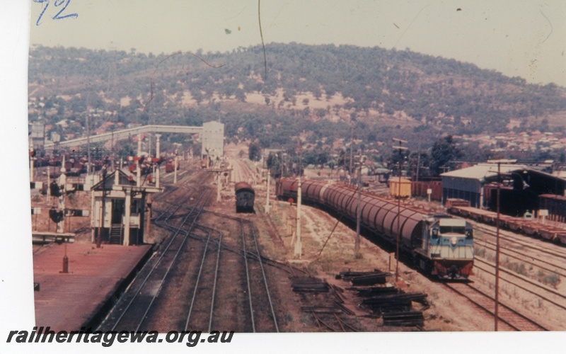 P16390
L class 259, in dark blue and light blue divided by a yellow stripe, on grain train, bracket signals, signal box, platform, carriage shed, Midland Junction, ER line, elevated view looking east
