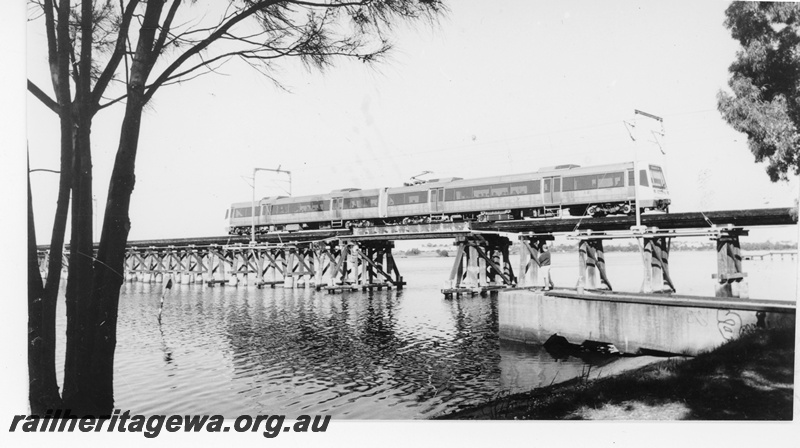 P16408
EMU two railcar set, crossing wooden trestle Bunbury bridge, East Perth, SWR line, c1993
