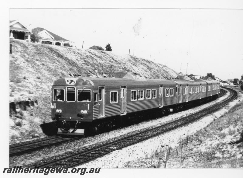 P16415
ADK class three railcar set, passing through cutting, houses, footbridge, Victoria Park, SWR line, front and side view
