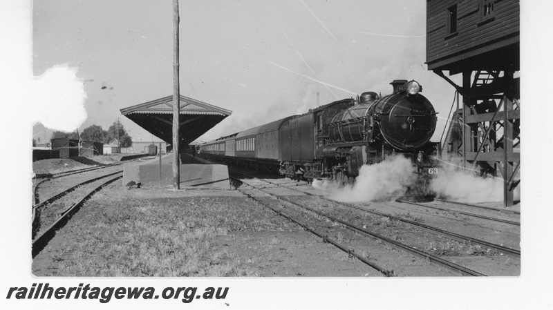 P16461
Commonwealth Railways (CR) C class loco on passenger train, platform, canopy, water tower, Kalgoorlie, TAT line
