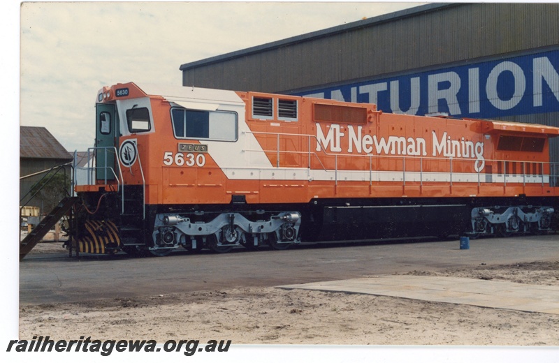P16511
Mount Newman Mining GE Dash 8 class 5630, in orange and white livery, end and side view
