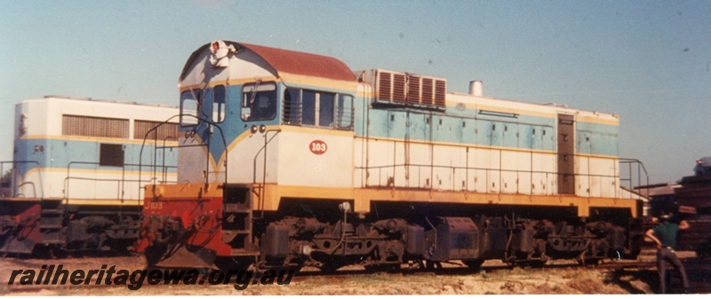 P16539
J class 103, in dark and light blue livery with yellow stripe, onlooker, end and side view
