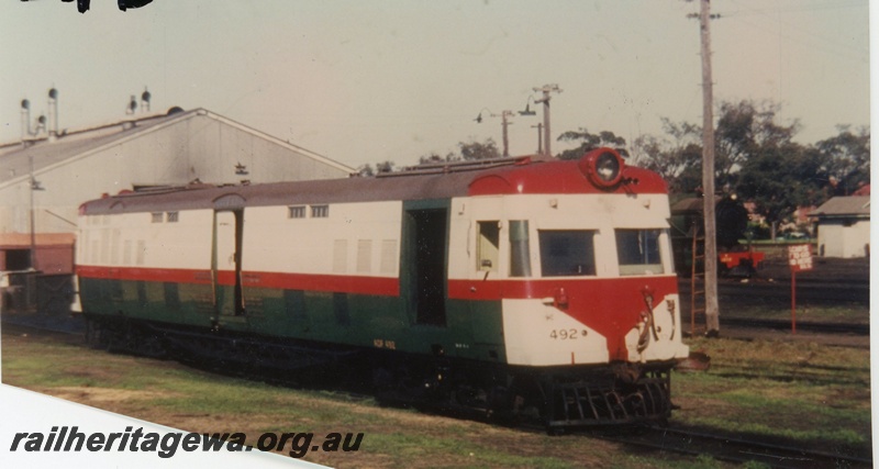 P16558
ADF class Wildflower railcar 492, in red, white and green livery, East Perth, side and front view
