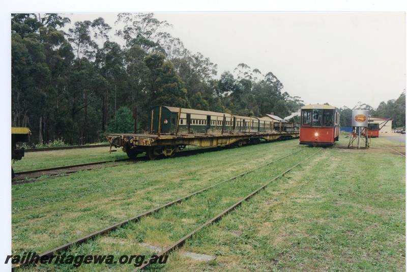 P16572
AYE/V class 708 carriage, two AYB class carriages, diesel tram No 1, another diesel tram, fuel tank, station building, forest, Pemberton Tramway, end and side views 
