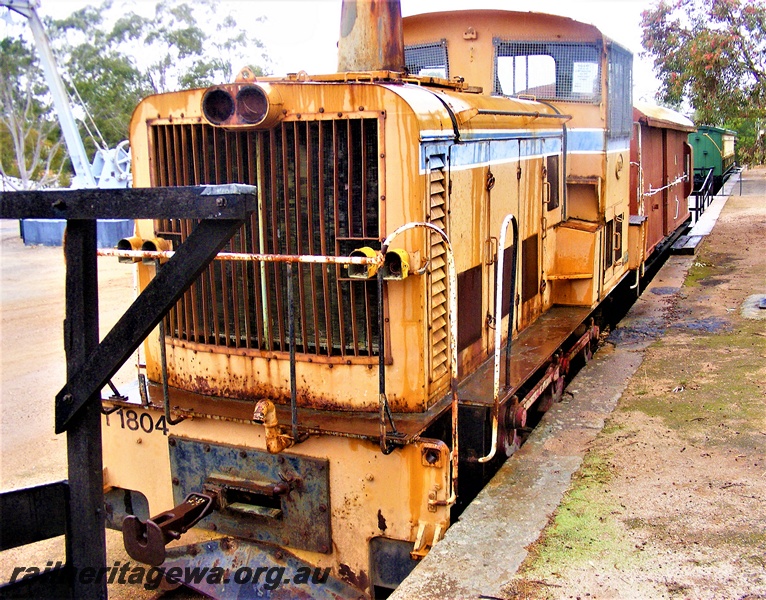 P16608
T class 1804, in Westrail orange with blue and white stripe livery, other rolling stock, Northampton Railway Precinct, GA line, front and side view
