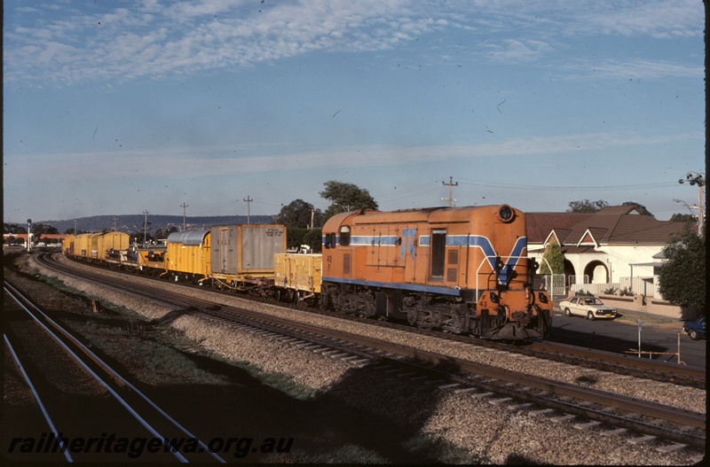 P16655
F class 43, in Westrail orange with blue and white stripe livery, on goods train including wagons, vans, flat top wagon with container No 5001, near Midland, ER line, side and front view
