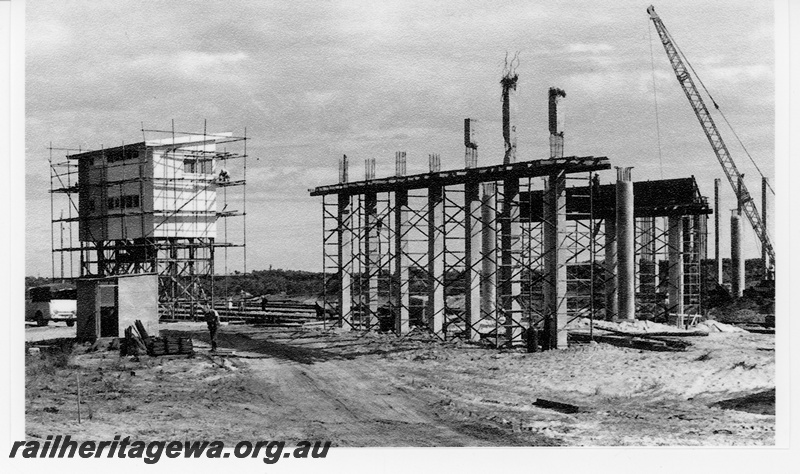 P16704
1 of 2 images of signal box and road overpass under construction, shed, workers, mobile crane, Kwinana, view from next to tracks
