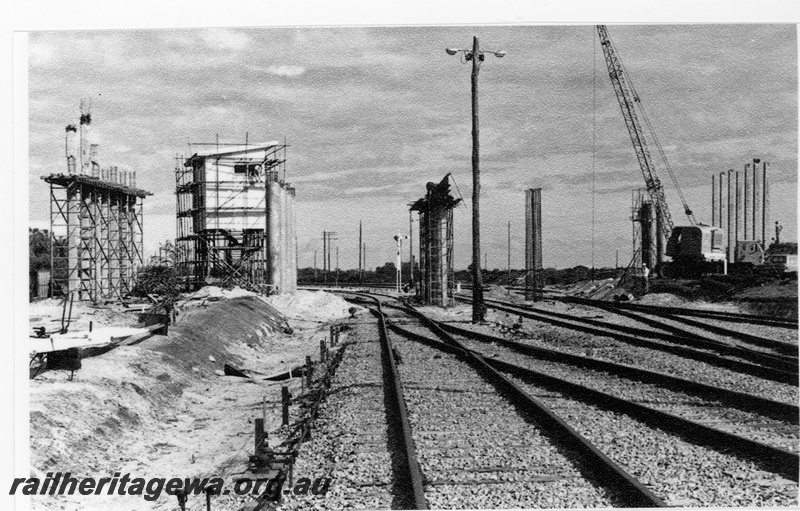 P16705
2 of 2 images of signal box and road overpass under construction, trackwork, signal, workers, mobile crane, Kwinana, view from tracks
