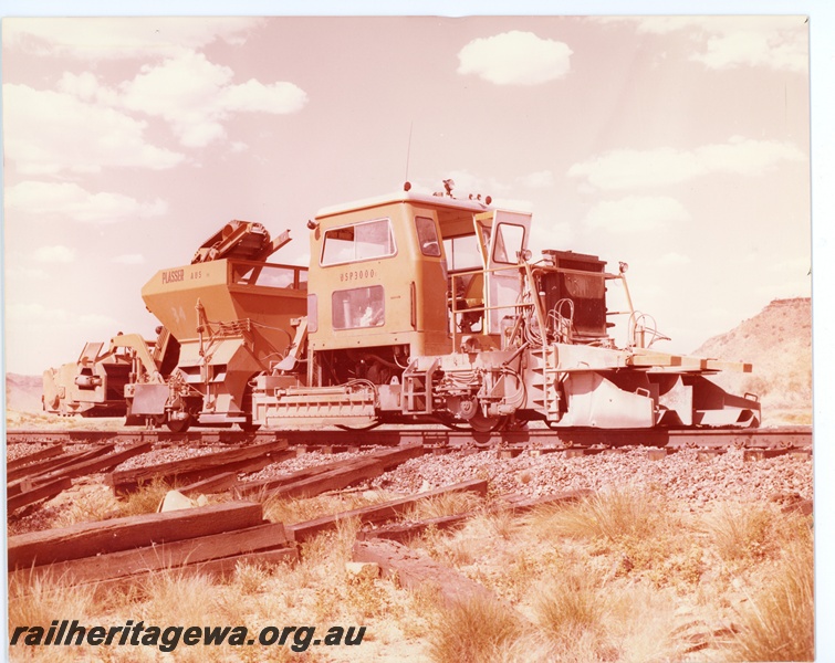 P16734
Mount Newman Mining Plasser USP 3000 ballast regulator, Mount Newman Railway, side and front view
