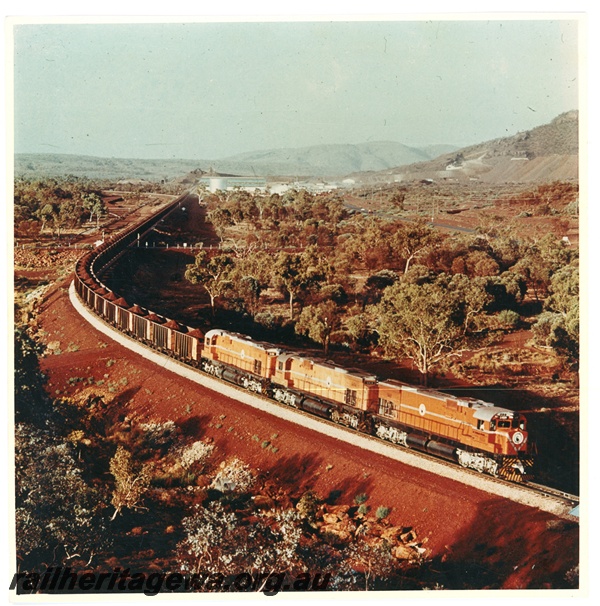 P16740
Mount Newman (MNM) C636 class 5462, 5454, 5461 lead a loaded ore train from Mount Whaleback. Mount Whaleback in background.
