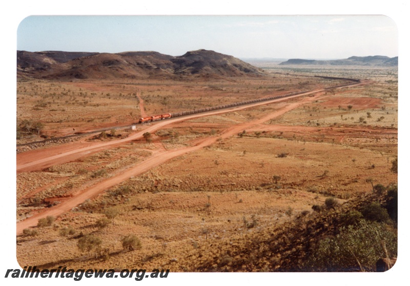 P16748
Mount Newman (MNM) distant view of Garden Loop with train waiting at the crossing loop.
