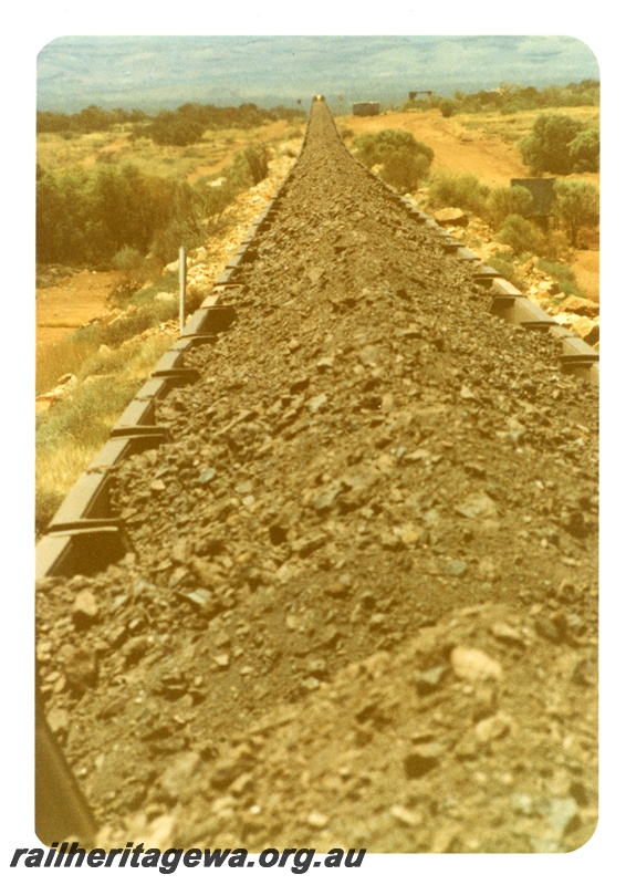 P16749
Mount Newman (MNM) looking along 2.5kms of loaded ore cars taken from cab of rear locomotive. 
