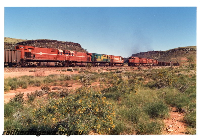 P16757
Mount Newman (MNM) M636 class 5502, 5488 (bi centennial livery), 5472, 5490 cross a 192 car loaded train at Garden loop.
