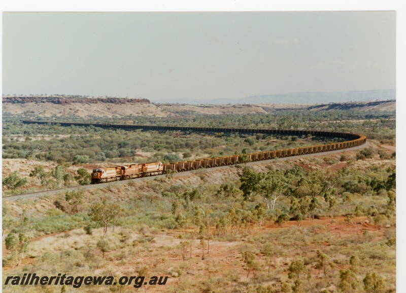 P16765
Mount Newman (MNM) triple headed ore train near Garden. Distant view.
