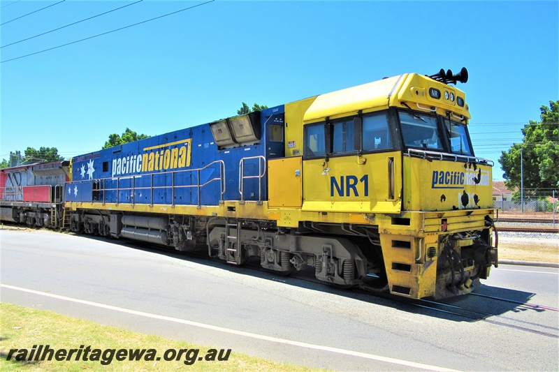 P16786
Pacific Nation loco NR class 1 crossing Railway Parade, Bassendean, side and front view
