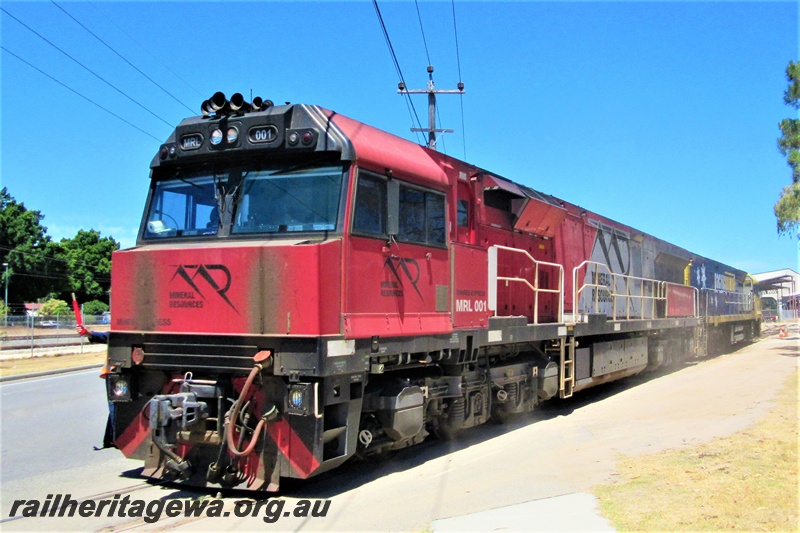 P16787
Mineral Resources loco MRL class 001 being towed by Pacific National loco NR class 1 across Railway Parade, Bassendean front and side view
