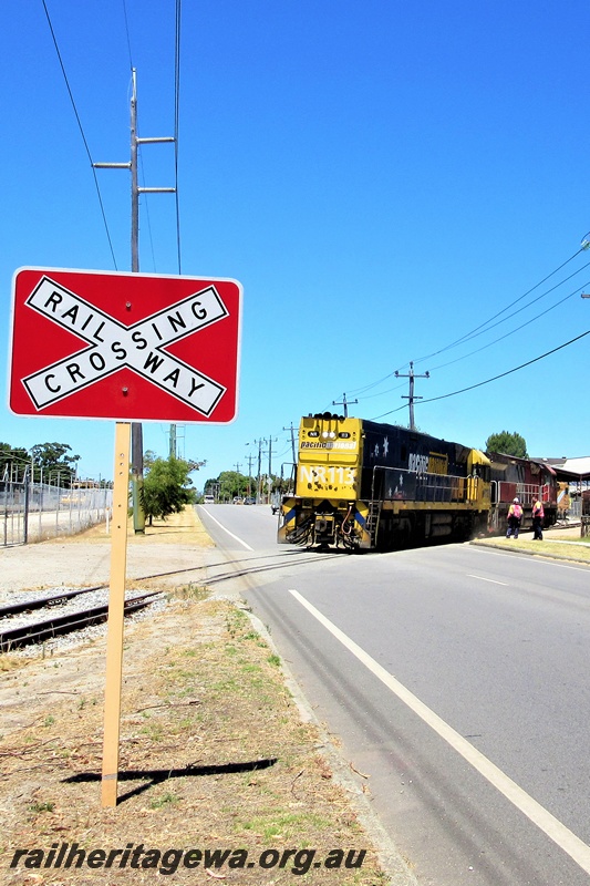 P16791
Pacific National loco NR class 113 towing a Mineral Resources loco across Railway Parade, Bassendean 