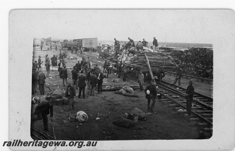 P16800
Commonwealth Railways (CR) - TAR line unloading material at an Unknown construction camp. c1916
