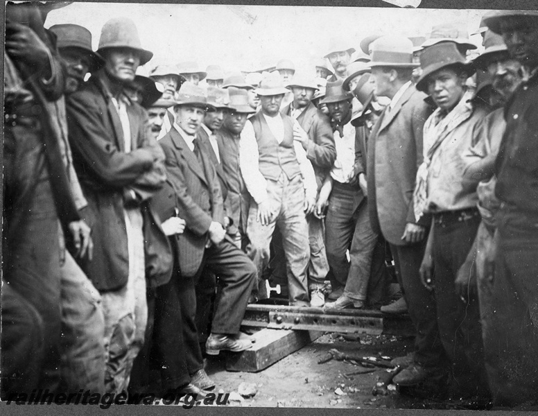 P16832
Commonwealth Railways (CR) - TAR line track workers inspect the joining of the railway.
