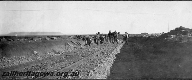 P16837
Commonwealth Railways (CR) - TAR line track workers spreading ballast. C1916
