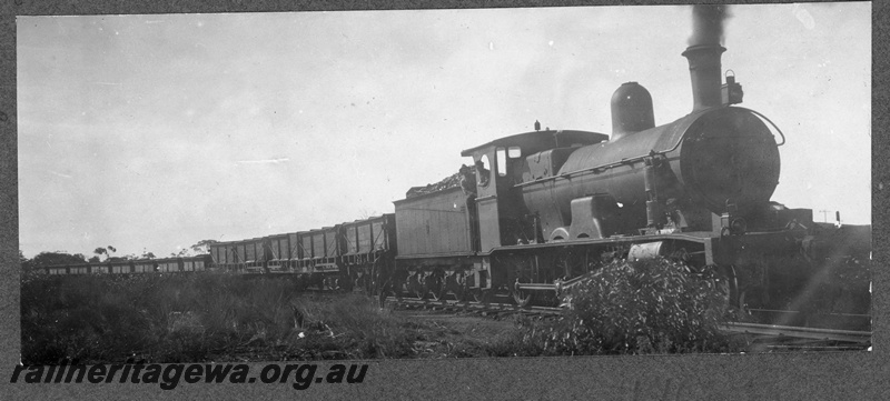 P16838
Commonwealth Railways (CR) G class steam locomotive east bound hauling ballast train at an Unknown location. TAR line. Note the wooden TA class tank wagon and the two TC class water tank wagon behind the locomotive.
