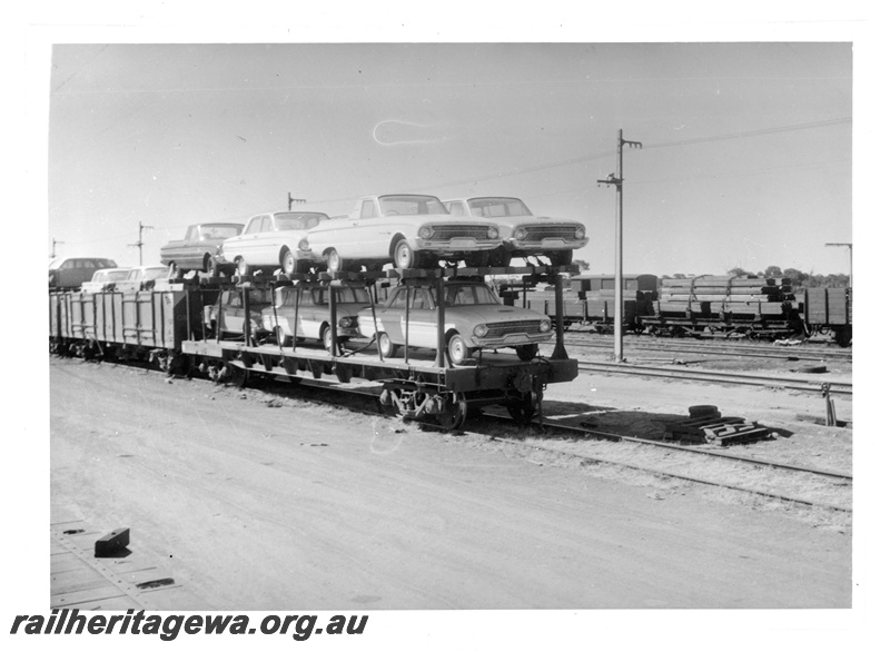 P16871
Commonwealth Railways (CR) - TAR line Ford Falcon motor vehicles on CR car transporter wagon preparing to be trans-shipped onto WAGR narrow gauge wagon at Parkeston 
