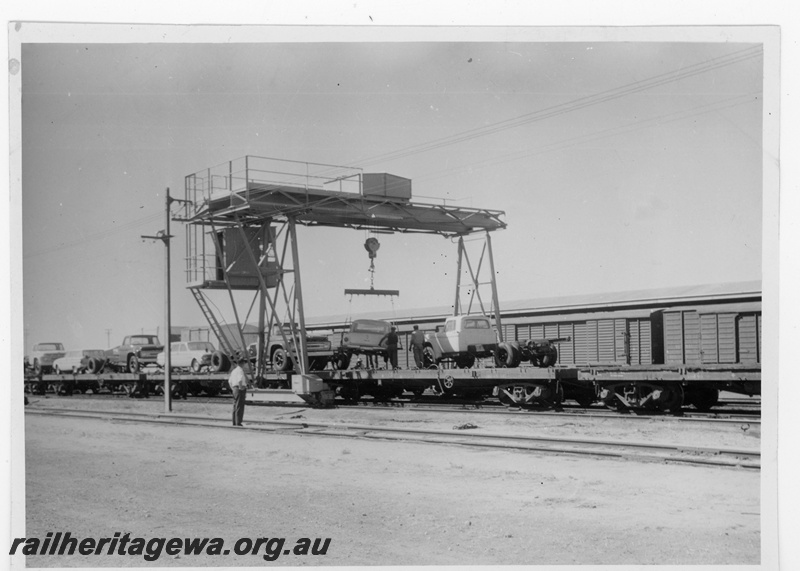 P16874
Commonwealth Railways (CR) - TAR line gantry crane at Parkeston trans-shipping vehicles from standard gauge to narrow gauge.
