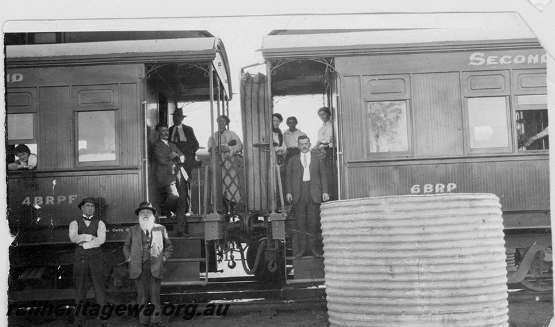 P16971
Commonwealth Railways (CR) passenger cars 4BRPF and 6BRP (part only), passengers, water tank, side view
