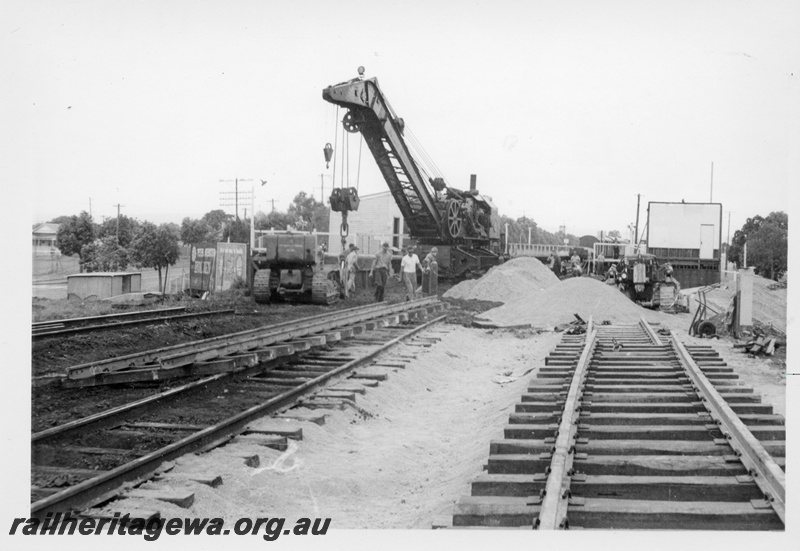 P17015
Cowans Sheldon 60 ton Breakdown Crane No 31, demolition of station, bulldozer, tracks, station buildings, West Midland, ER line.
