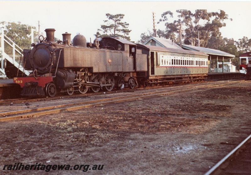 P17054
DD class 593 hauling the 6.10pm Armadale - Perth train. SWR line, Note portion of the footbridge to right of locomotive, station building and Railcar in background.
