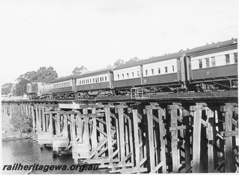 P17058
An unidentified AA class diesel locomotive at he head of an unidentified passenger train travelling over the Guildford Bridge enroute to Perth. ER line.
