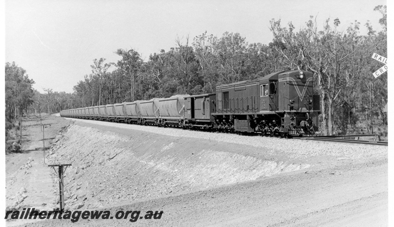P17133
R class 1904 diesel electric locomotive hauling a loaded bauxite train of XB class hopper wagons on the Jarrahdale line. These wagons were subsequently sold to New Zealand for use in coal haulage. 
