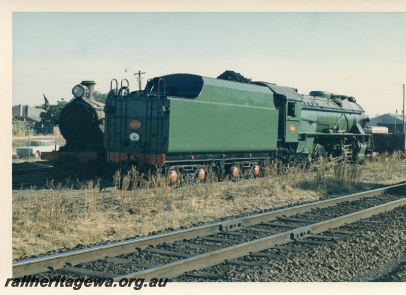 P17158
V class 1205 locomotive at East Perth loco at eastern end. Unidentified locomotive to side of V class.
