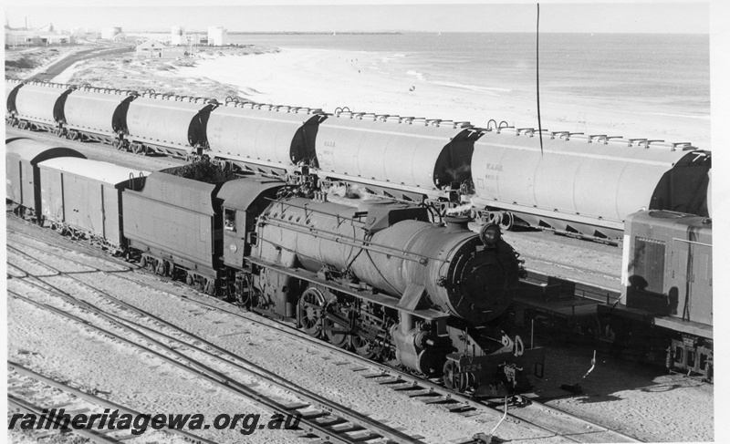 P17177
V class1224, on goods train No 56, rake of WAGR wheat wagons and nose of diesel shunter on other tracks, Leighton yard, ER line
