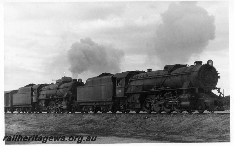 P17252
2 of 2, V class steam locomotives double heading on a goods train, side and front view, country location.
