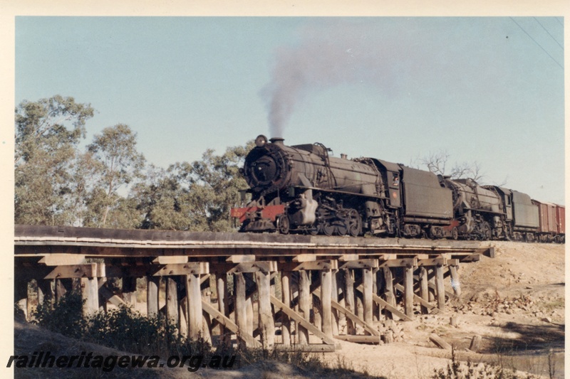P17254
V class 1221 steam locomotive double heading with V class steam locomotive double heading on goods train, front and side view, crossing the Hotham River bridge, near Pingelly, GSR line.
