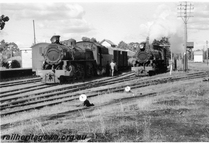 P17322
PMR class 730 and PR class steam locomotives at Chidlow. Note the brakevan on the adjacent line to the PMR, crews on ground conversing. Cheese knob points in foreground and water tower in background. ER line.

