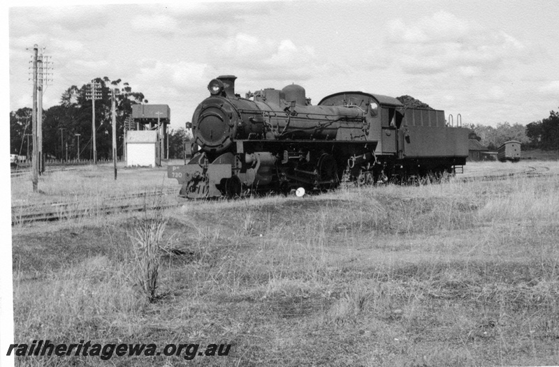 P17323
PMR class 730 steam locomotive at Chidlow. Side and 3/4 front view of locomotive, cheese knob points next to locomotive, water tower and pump house to right of scene together with overhead power lines. ER line.
