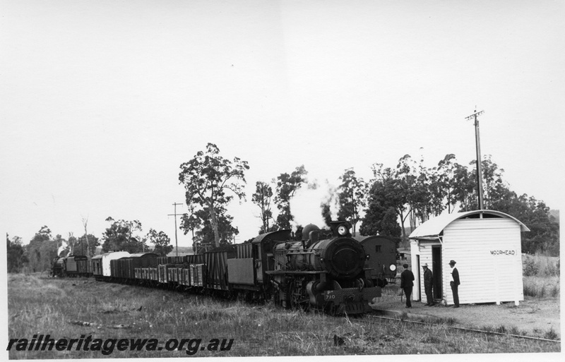 P17327
PM class 710 steam locomotive, side and front view, crossing another goods train, out-of shed, cabin, nameboard, Moorhead, BN line.
