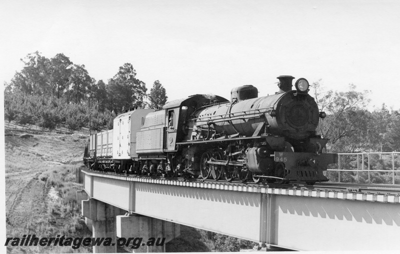 P17445
 W class 945 steam locomotive hauling a goods train on the Balingup Bridge. PP line. Front & side view of locomotive and partial side view of EB class ice cooled wagon.
