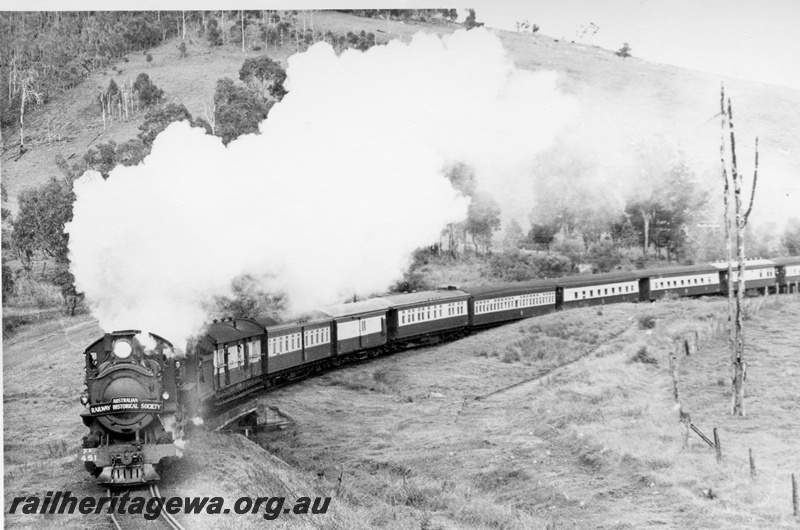 P17589
4 of 4, FS class 451 steam locomotive double heading with FS class 420 steam locomotive on Reso train, front view of leading locomotive and side view of carriages, crossing a culvert, heading up the grade near Beela, BN line.
