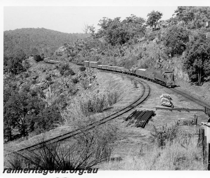 P17597
An unidentified A class diesel locomotive hauling a goods train towards the Swan View Tunnel. ER line. 
