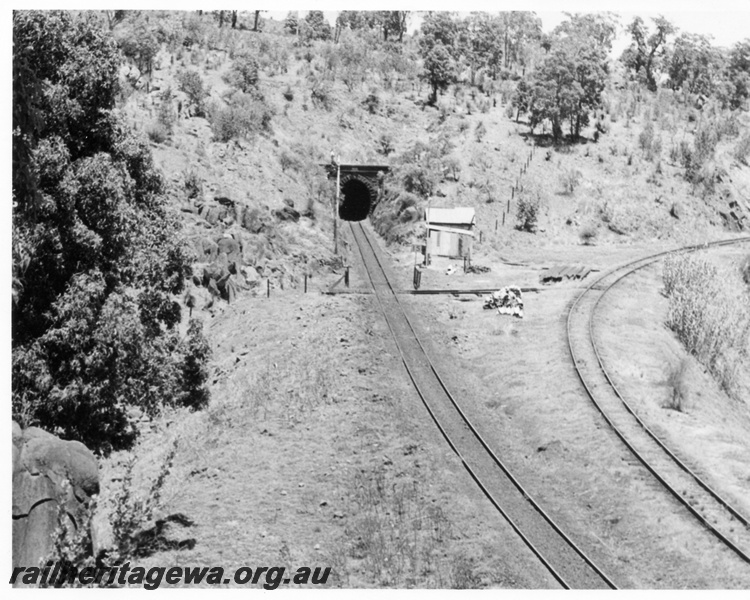 P17606
An elevated view of the entrance to the Swan View tunnel heading west. The deviation line to the east is to the right. ER line. Note the per way equipment between the two tracks and former signal box next to the trolley crossover.
