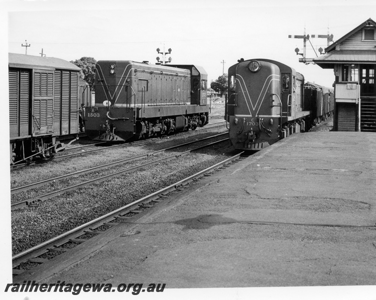 P17607
C class 1703 diesel locomotive hauling an eastbound goods train while A class 1503 diesel locomotive has uncoupled from its train at Midland. ER line. Note the semaphore signals, both main line and shunting. The signal box is at the end of the platform.
