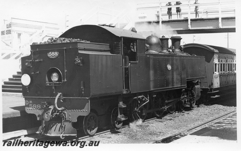 P17642
DM class 588 steam locomotive on an empty Royal Show train at Claremont. ER line. View of bunker rear and side view of locomotive. The upcoming train enthusiasts on the overhead footbridge.
