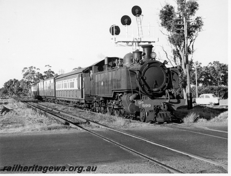 P17666
DD class 599, on 5:10 pm down suburban passenger train, searchlight signals, level crossing, Armadale, SWR line, c1966
