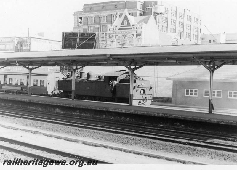P17703
DD class loco, bunker first, on passenger train, Perth station, ER line, c1966

