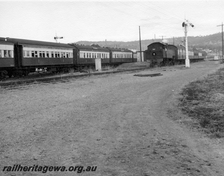 P17713
DD class 599, bunker first, on suburban passenger train, platform, signals, rake of passenger carriages, ER line, c1965
